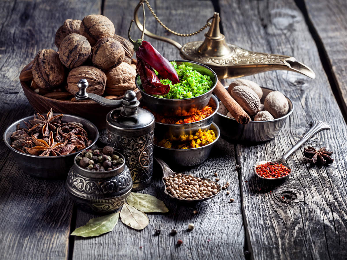 A picture of Indian herbs, nuts and an oil urn